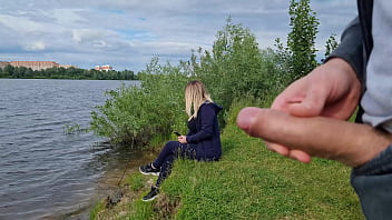 A man exposes himself to a solo girl in nature, masturbates in front of her, risking offense, but she enjoys the view and wishes to see his climax